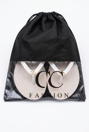 Black drawstring pouch with a transparent front showing jewelry and the text “CC FASHION”