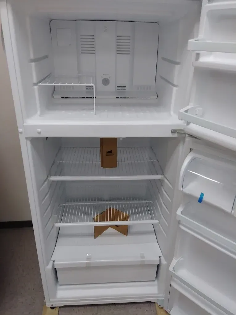 White, empty refrigerator interior; shelves, door storage, and freezer compartment visible.