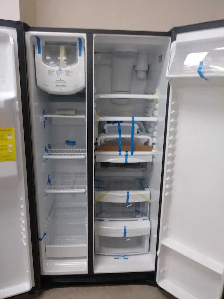 Black side-by-side refrigerator with doors open, empty shelves, water/ice dispenser on left door.