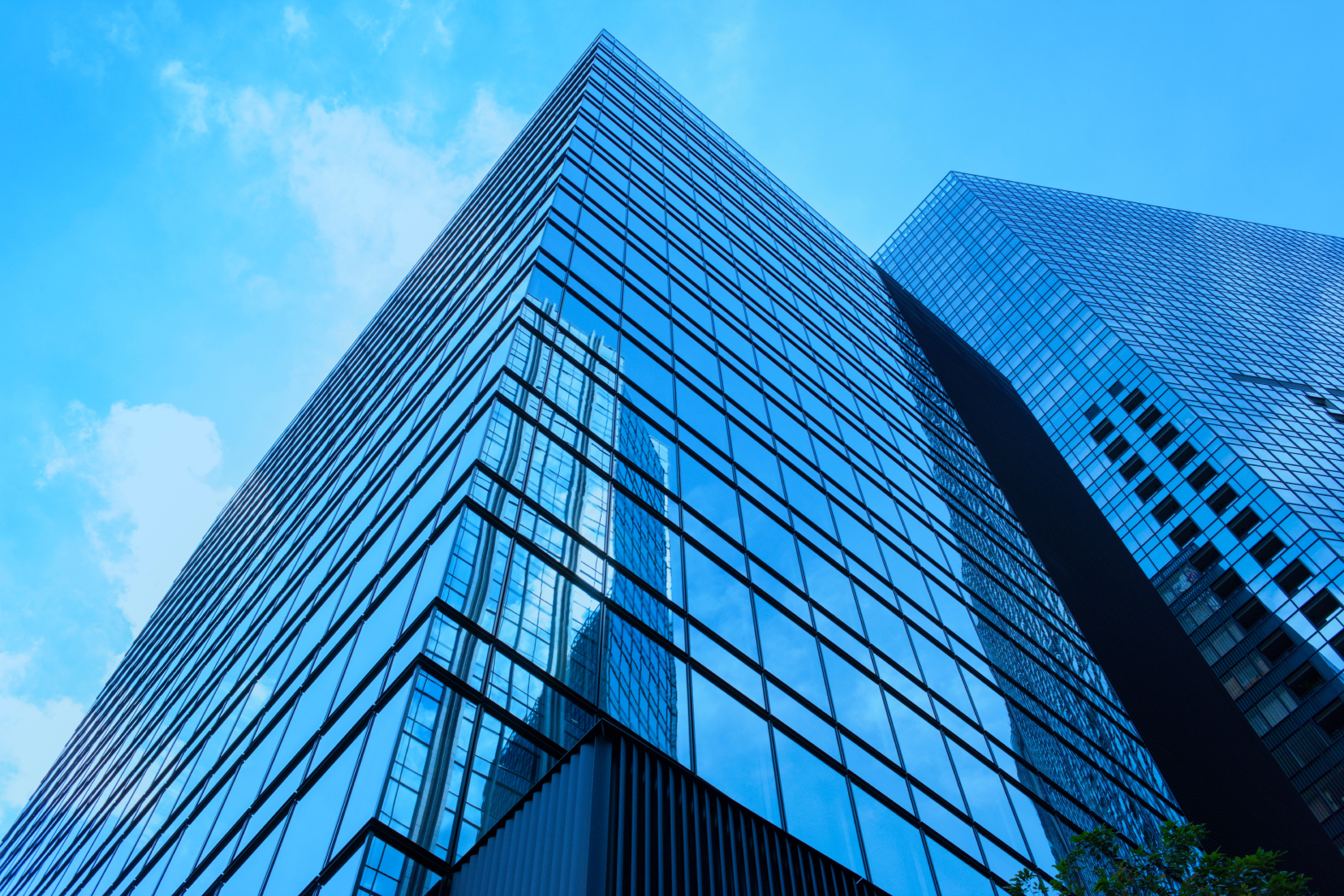 Looking up at a tall building with a blue sky in the background.