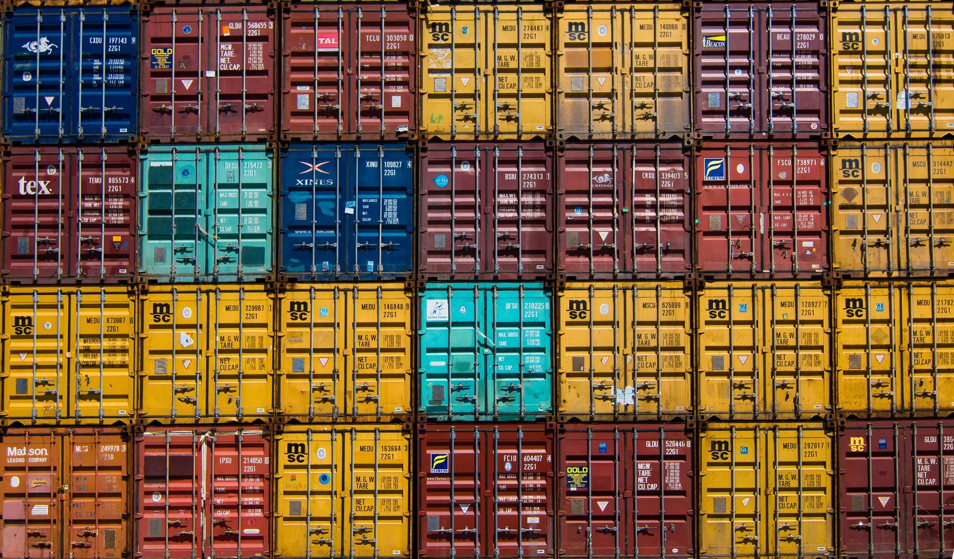 A bunch of shipping containers are stacked on top of each other.