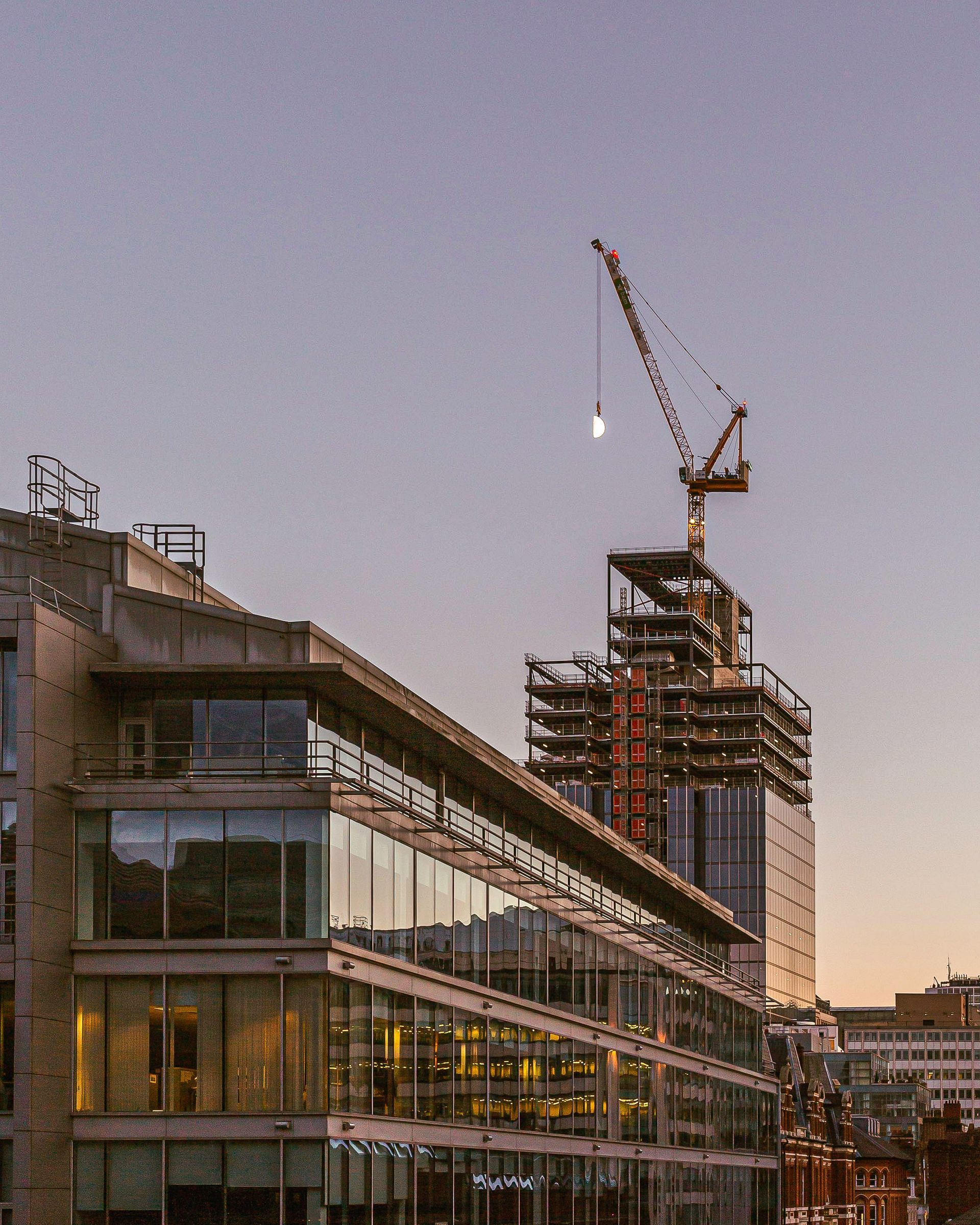 A building under construction with a crane in the background