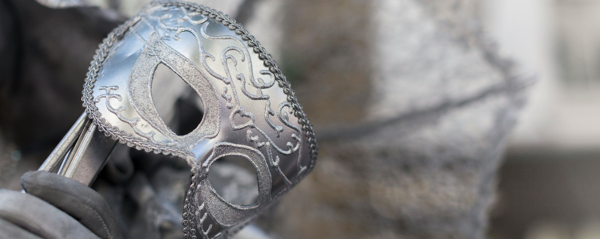 A person is holding a skull mask in their hand.