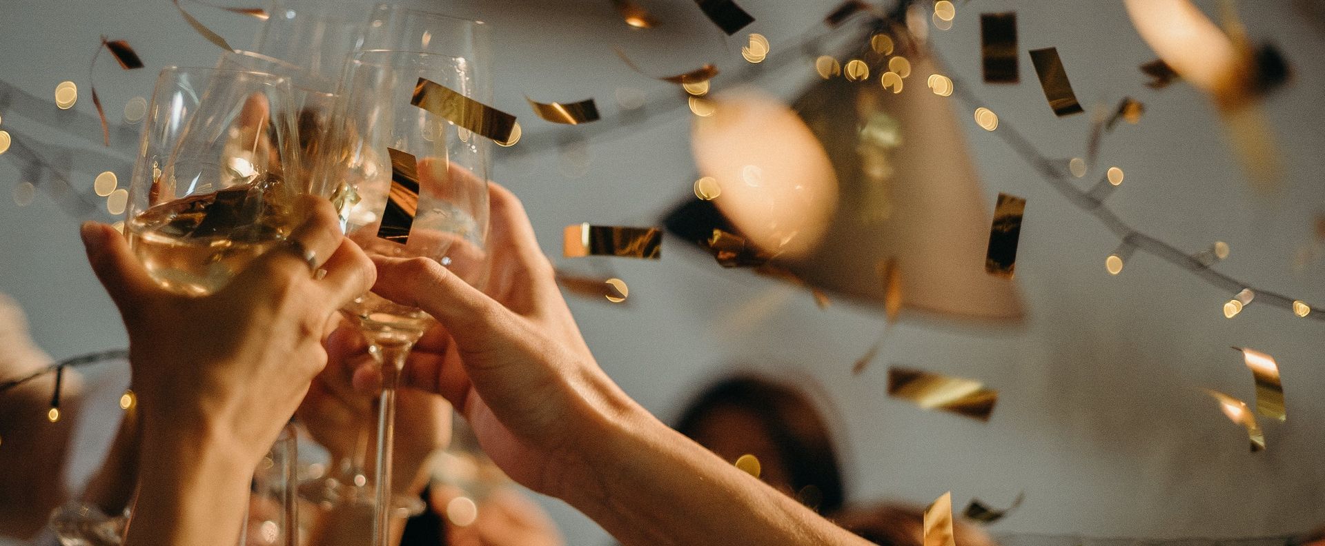 A group of people are toasting with champagne glasses at a party.