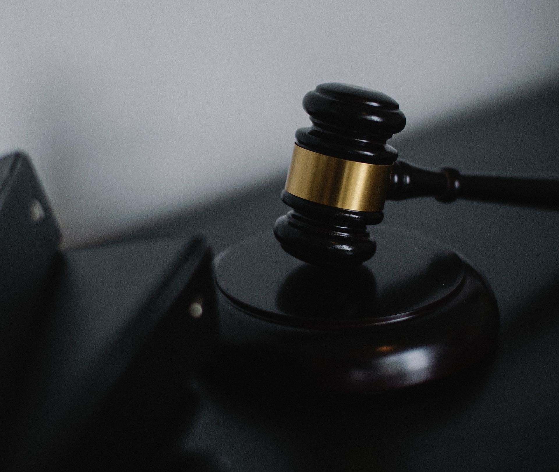 A judge 's gavel is sitting on top of a black table.