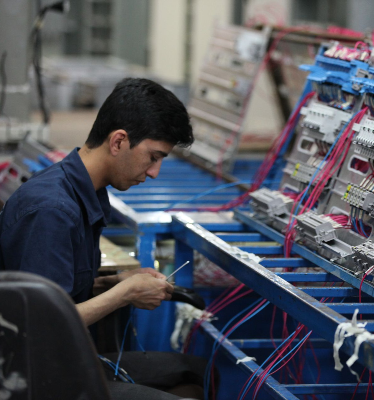 A man is working on a machine in a factory.