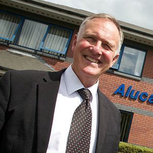 Alucast employee in front of their office building.
