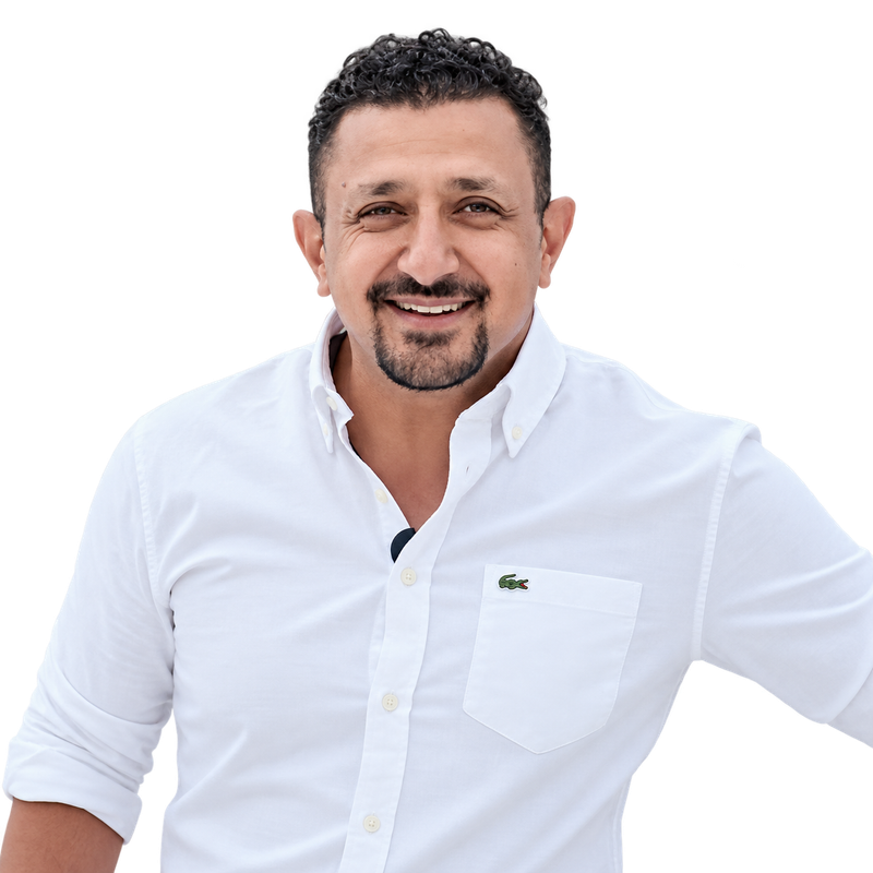 Smiling person in a white button-down shirt against a plain white background