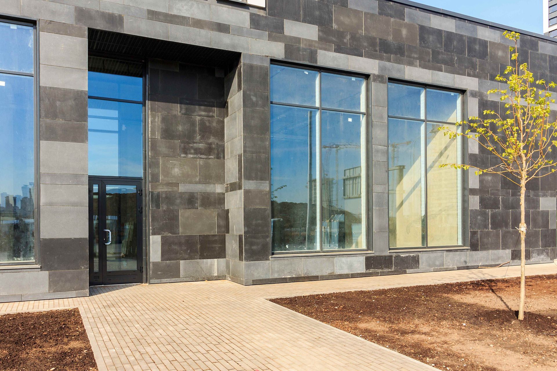 a large building with a lot of windows and a walkway leading to it