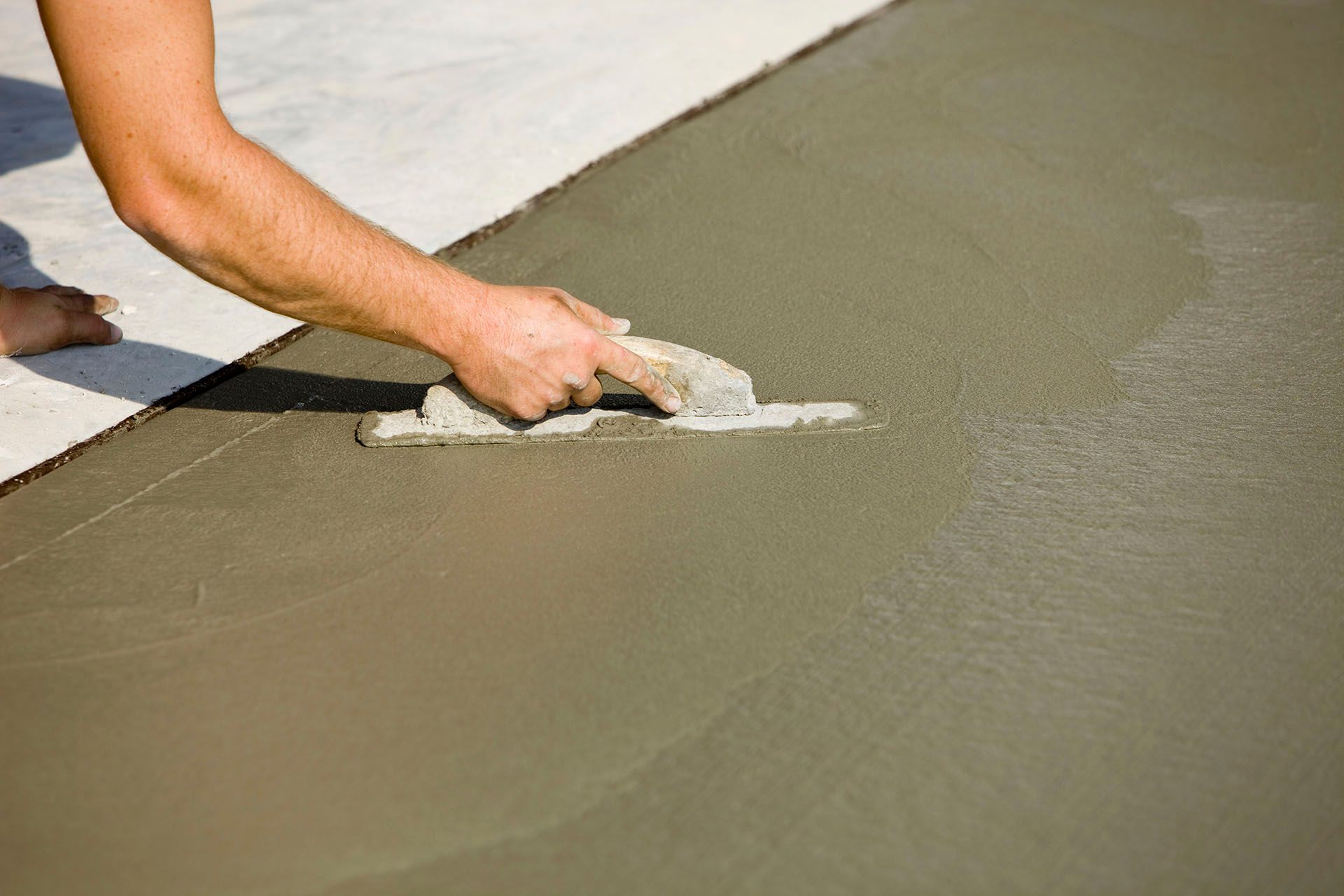 Smoothing Wet Cement — Lincoln, NE — M&D Concrete and Epoxy Flooring Inc.