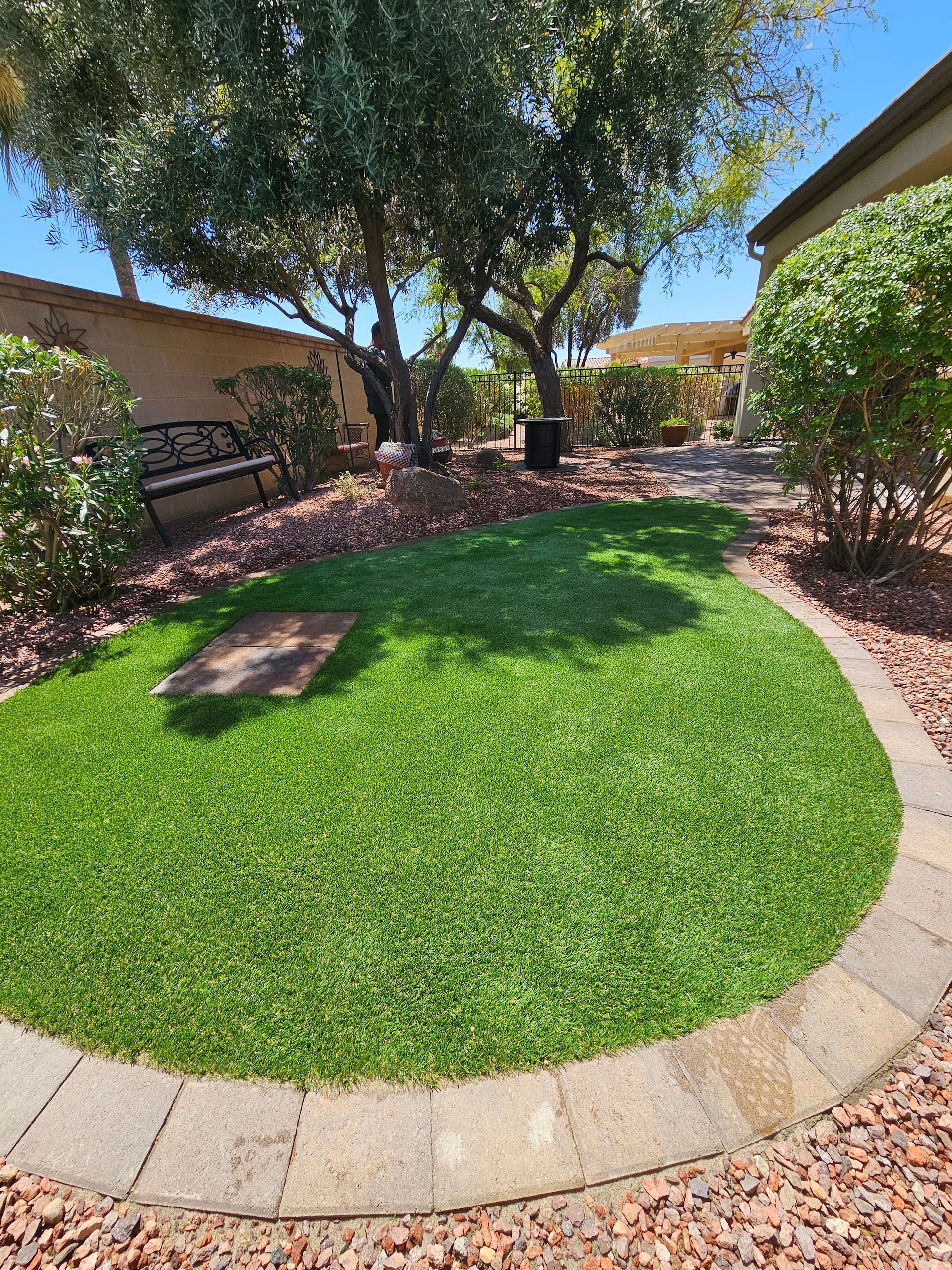 There is a circle of grass in the middle of the yard.