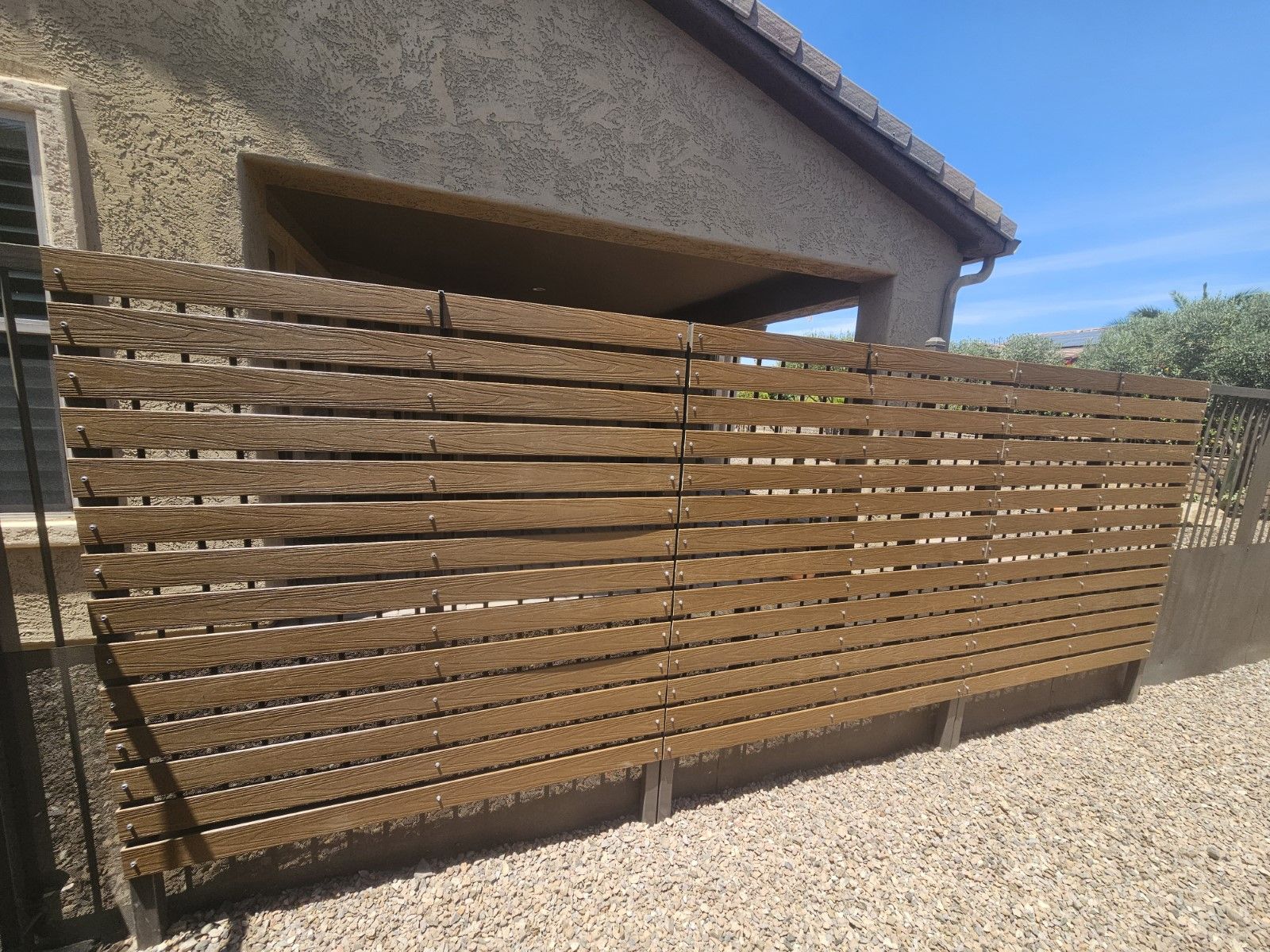 wrought iron fencing with wooden planks