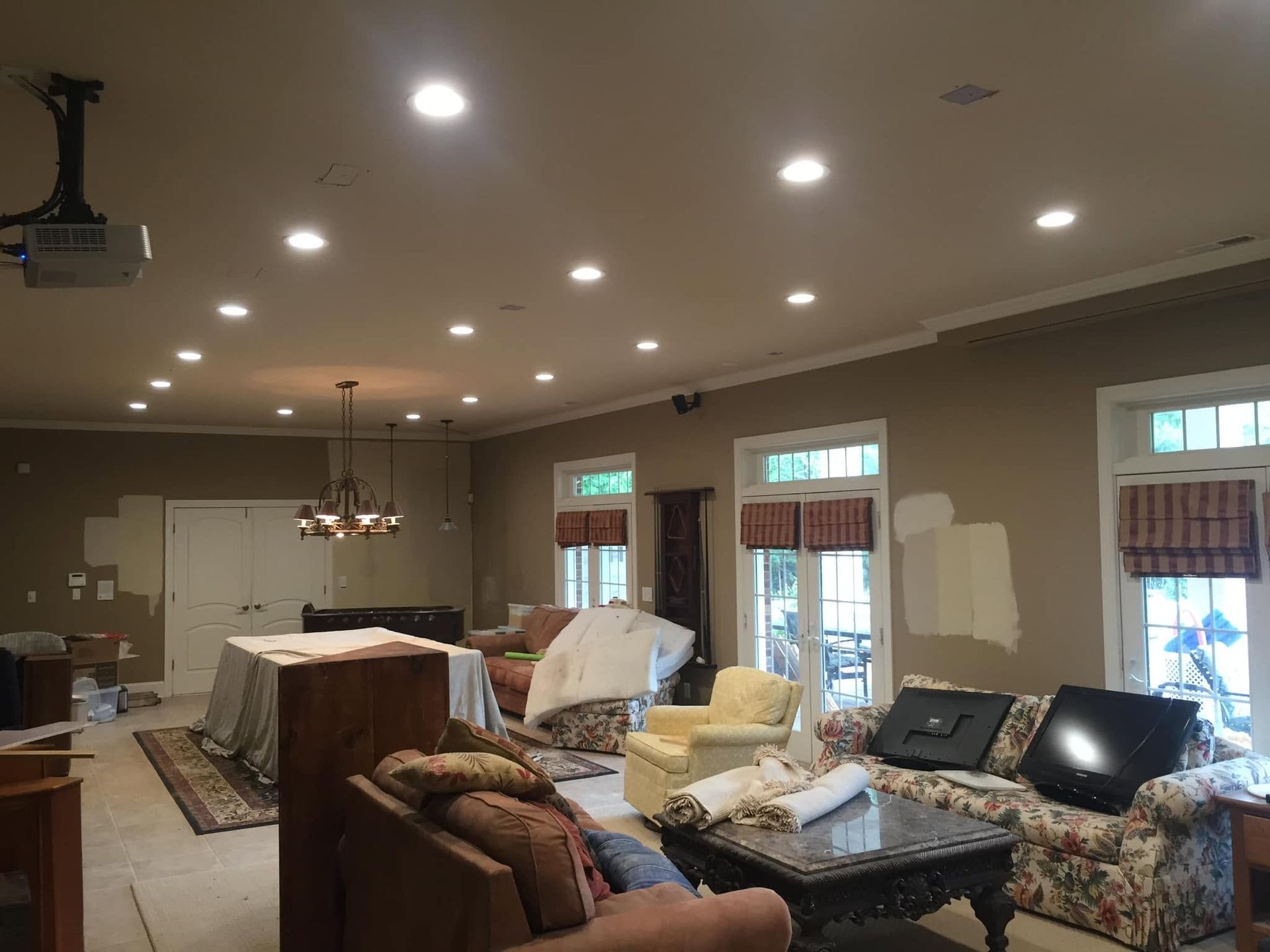 Open-concept living room with sofas, coffee table, rug, and recessed ceiling lights