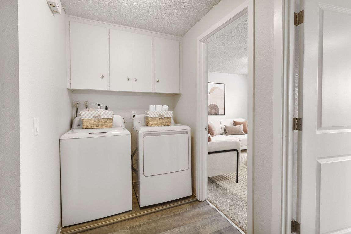 A laundry room with a washer and dryer in a house.