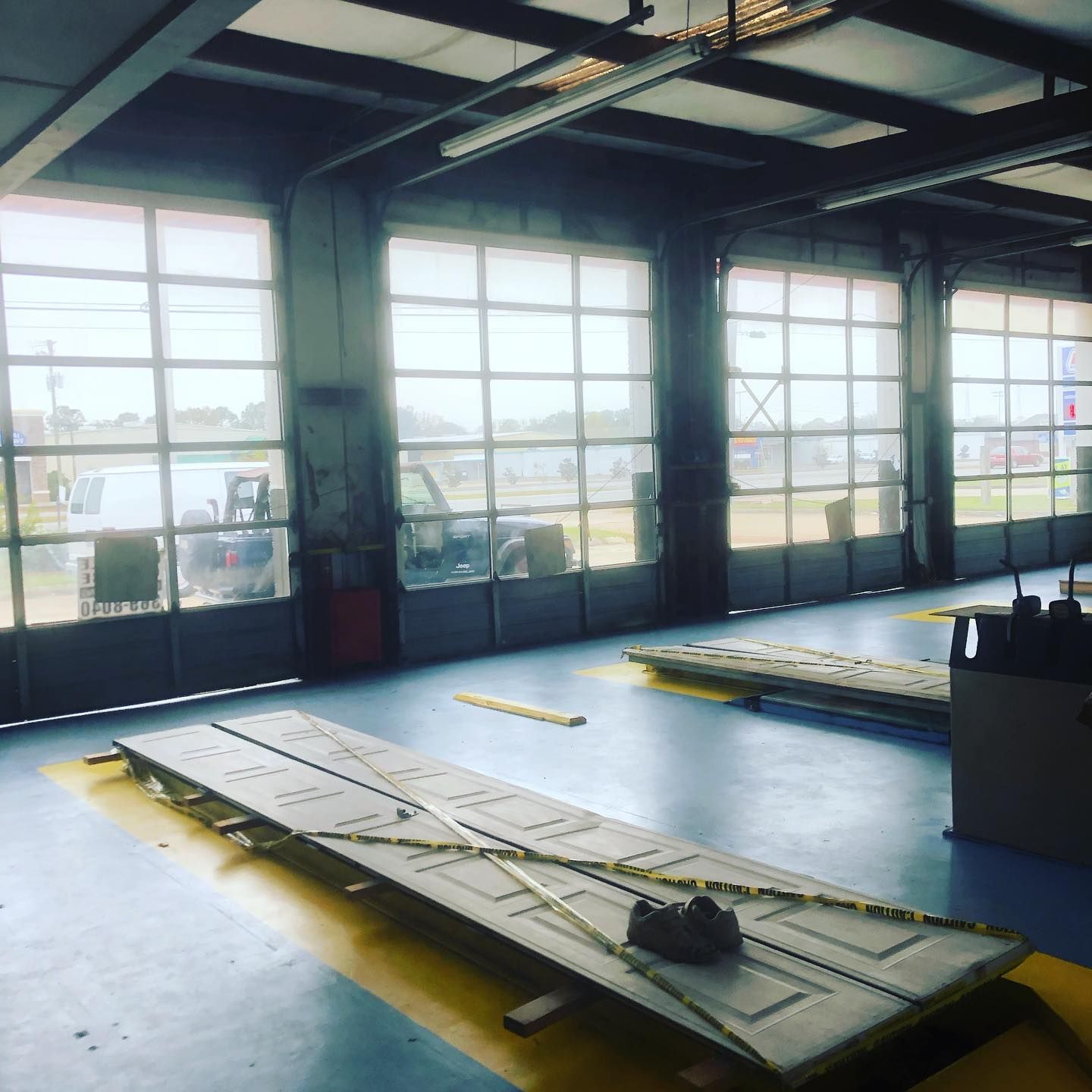 Industrial workshop with large windows and two flat carts on a concrete floor