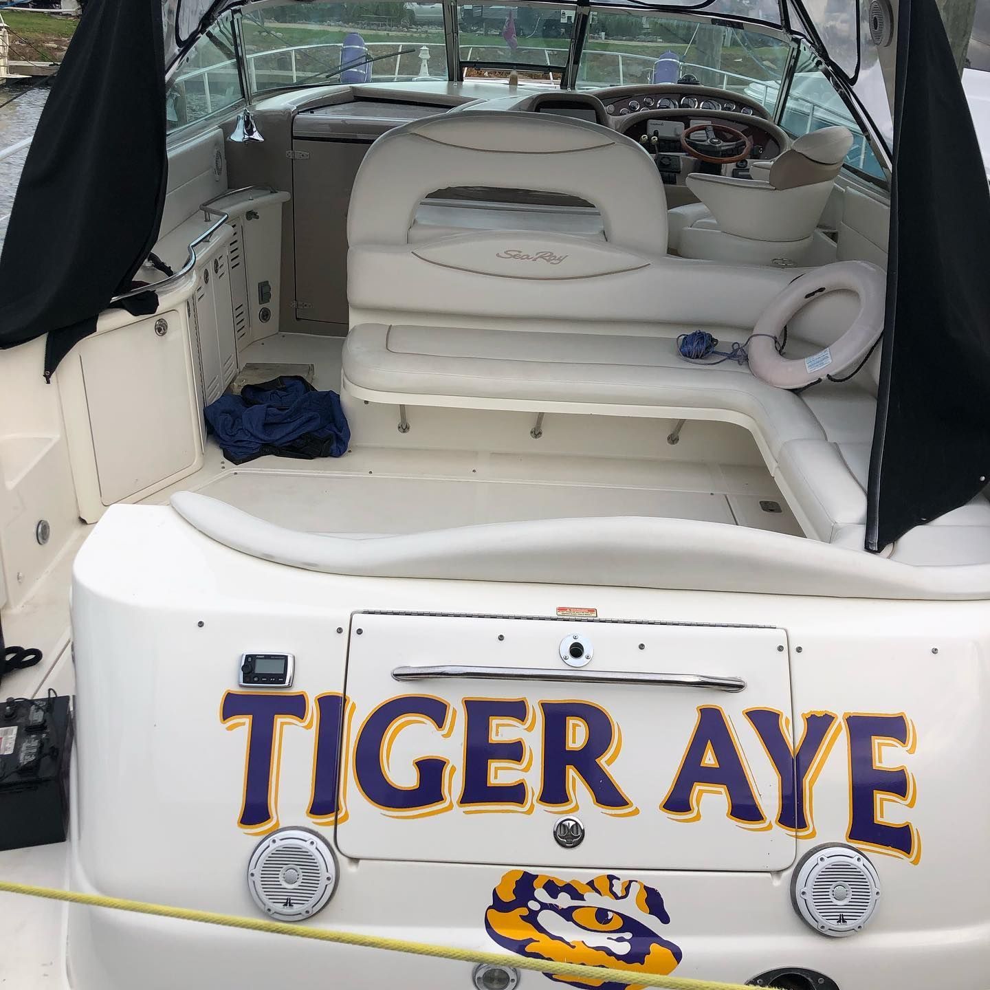 Boat stern with “TIGER EYE” lettering and a tiger logo, showing the cockpit seating area