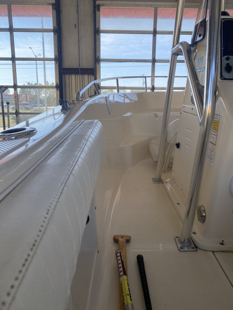 Interior of a white boat cabin with large windows and a mounted metal ladder