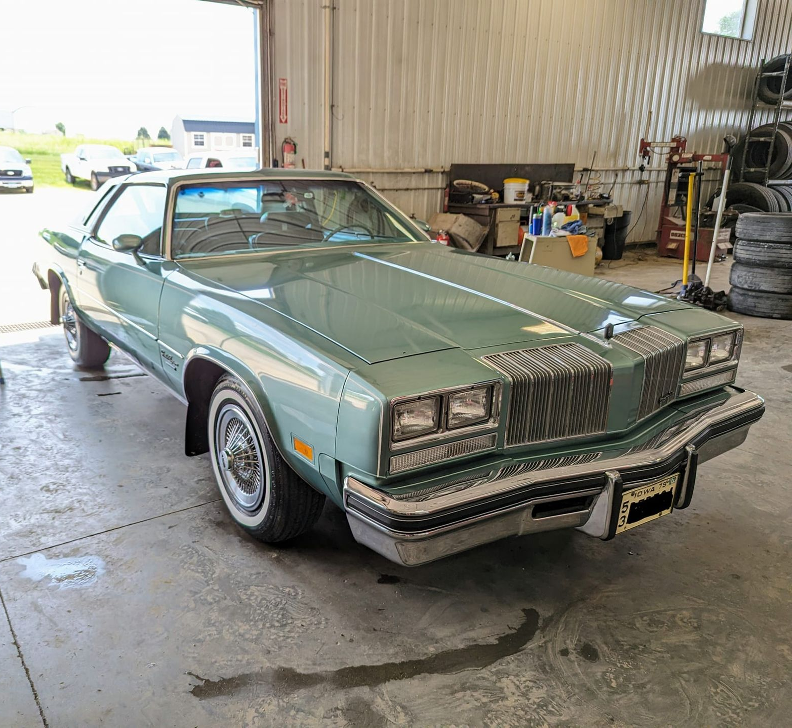 Green Oldsmobile Cutlass in a garage | Kerp's Service Center