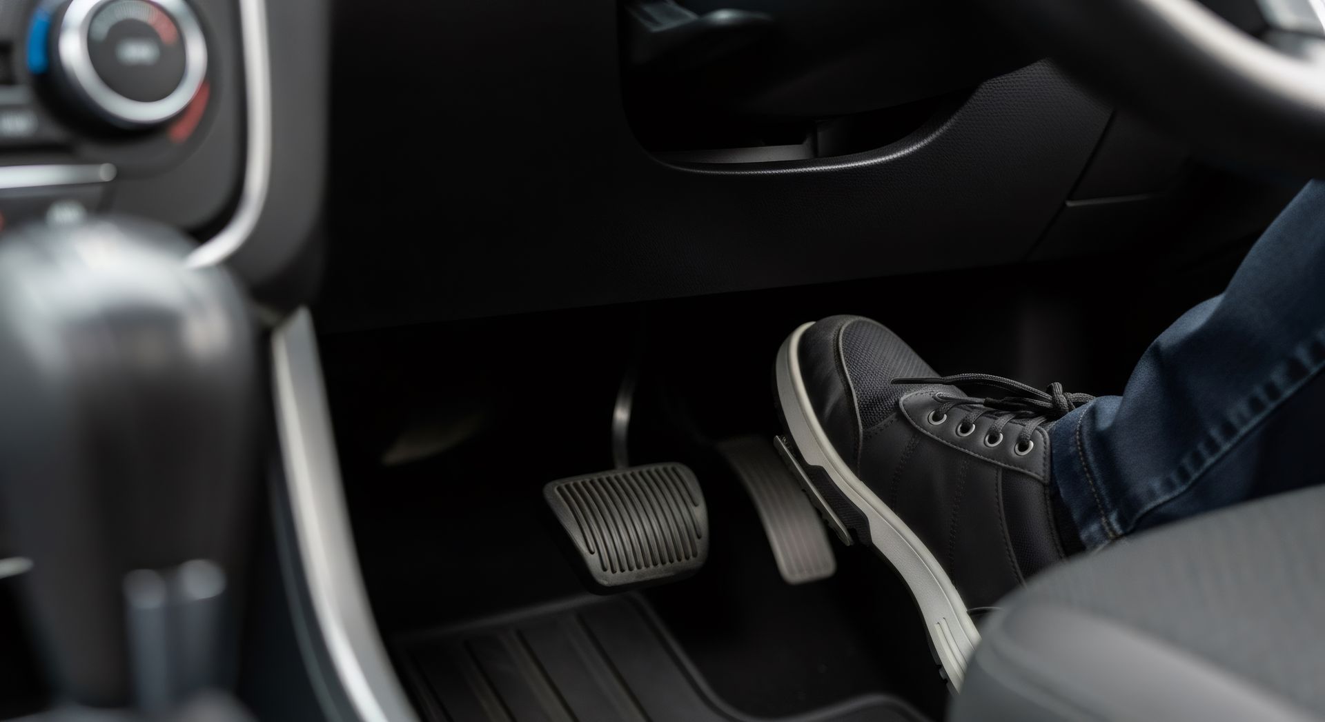 Foot pressing the accelerator pedal in a car. Foot pressing the accelerator pedal in a car.