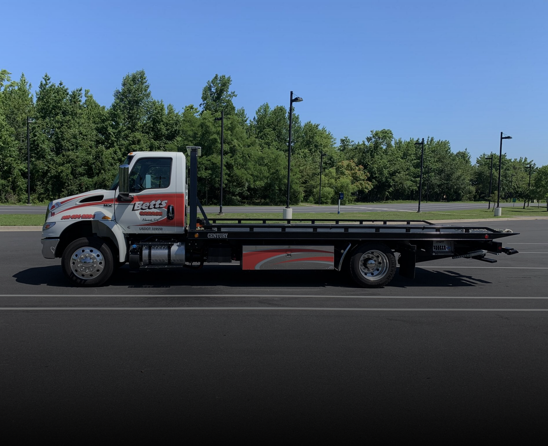 Betts Garage flatbed tow truck parked and ready for roadside service