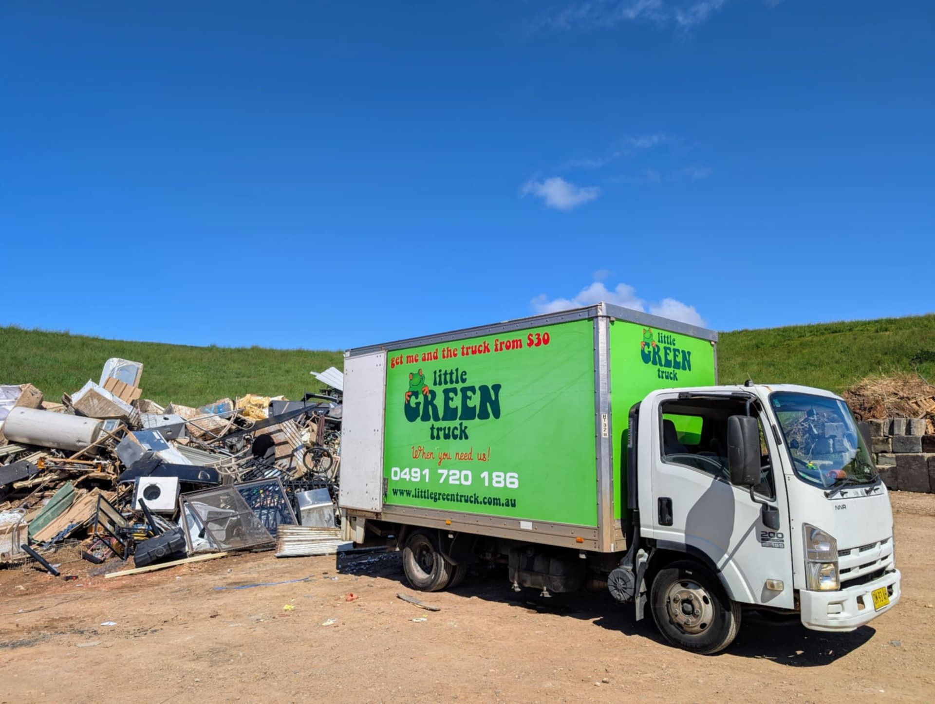 Two Men Are Standing in Front of a Green Little Green Truck — Little Green Truck Port Macquarie in Crescent Head, NSW