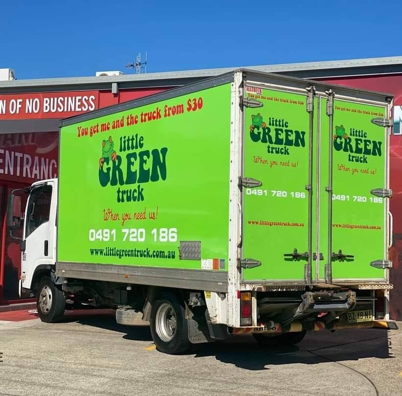 A Green Little Green Truck is Parked in Front of a Building — Little Green Truck Port Macquarie in Port Macquarie, NSW