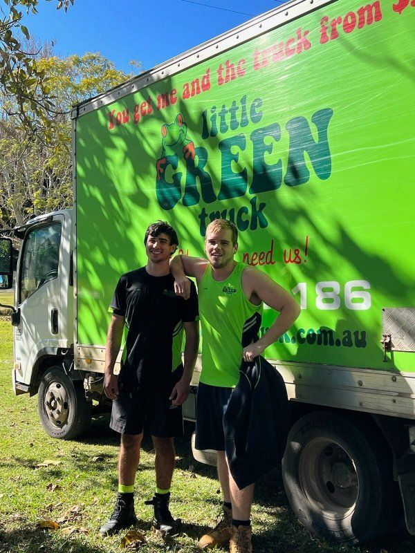 Two Men Are Standing in Front of a Green Little Green Truck — Little Green Truck Port Macquarie in Port Macquarie, NSW