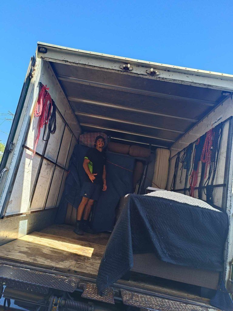 A Man is Standing in the Back of a Moving Truck — Little Green Truck Port Macquarie in Bonny Hills, NSW
