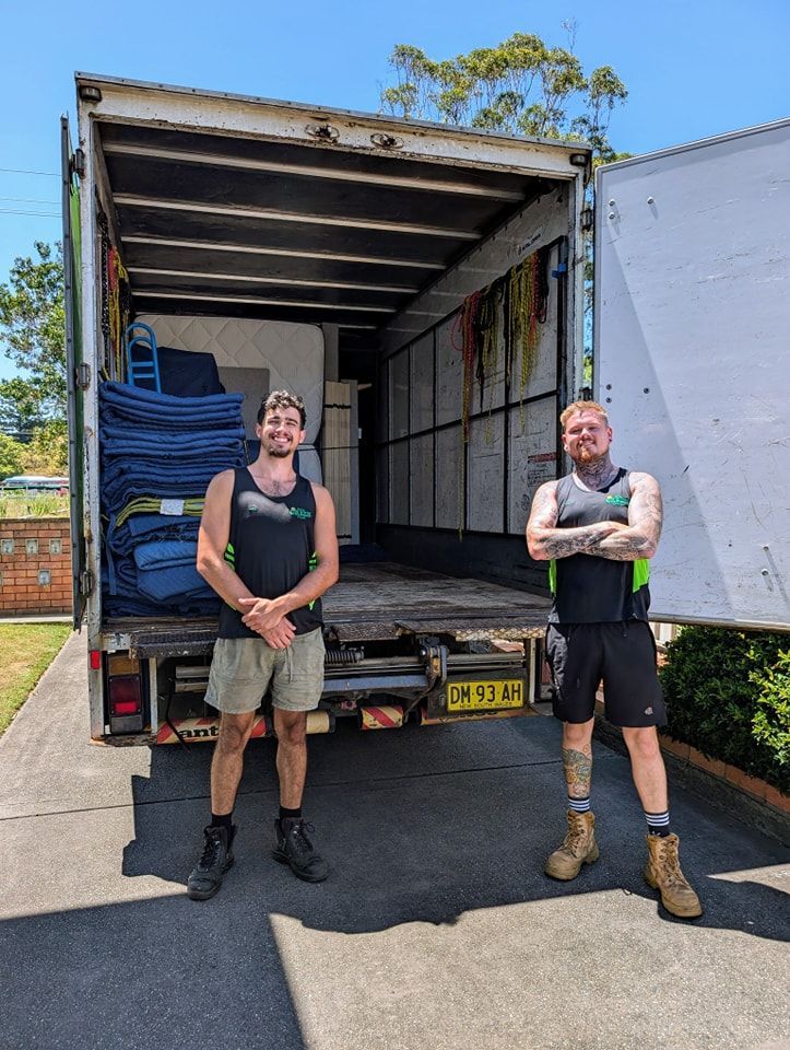 Two Men Are Standing in Front of a Moving Truck — Little Green Truck Port Macquarie in Laurieton, NSW