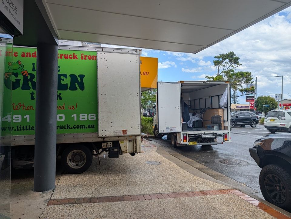 Two Moving Trucks Are Parked Next to Each Other — Little Green Truck Port Macquarie in Port Macquarie, NSW