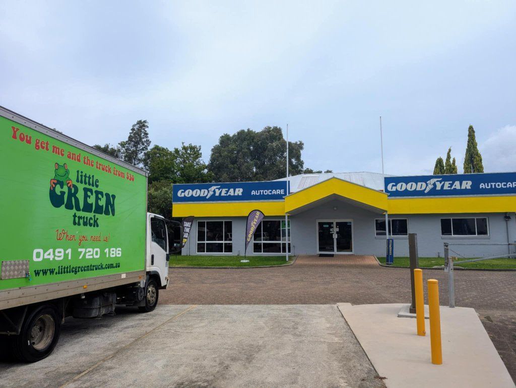 A Green Goodyear Truck is Parked in Front of a Building — Little Green Truck Port Macquarie in Port Macquarie, NSW