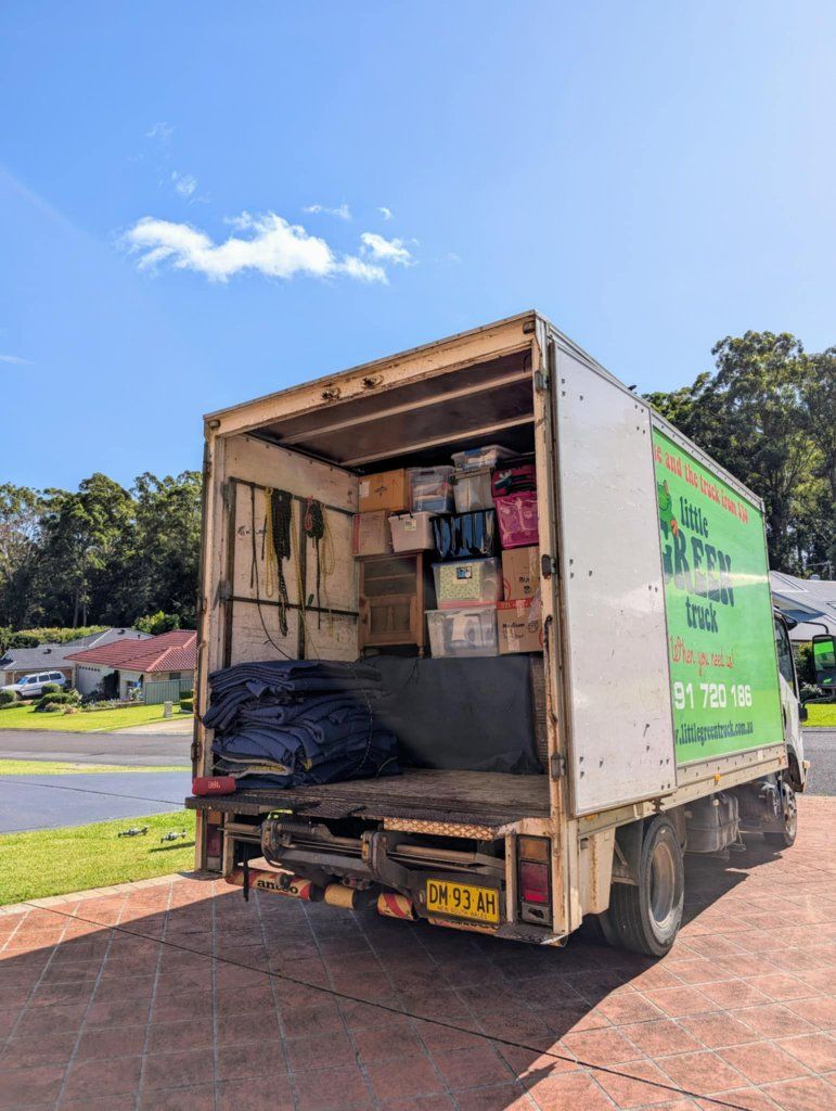 Two men are standing in front of a moving truck — Little Green Truck Port Macquarie in Port Macquarie, NSW