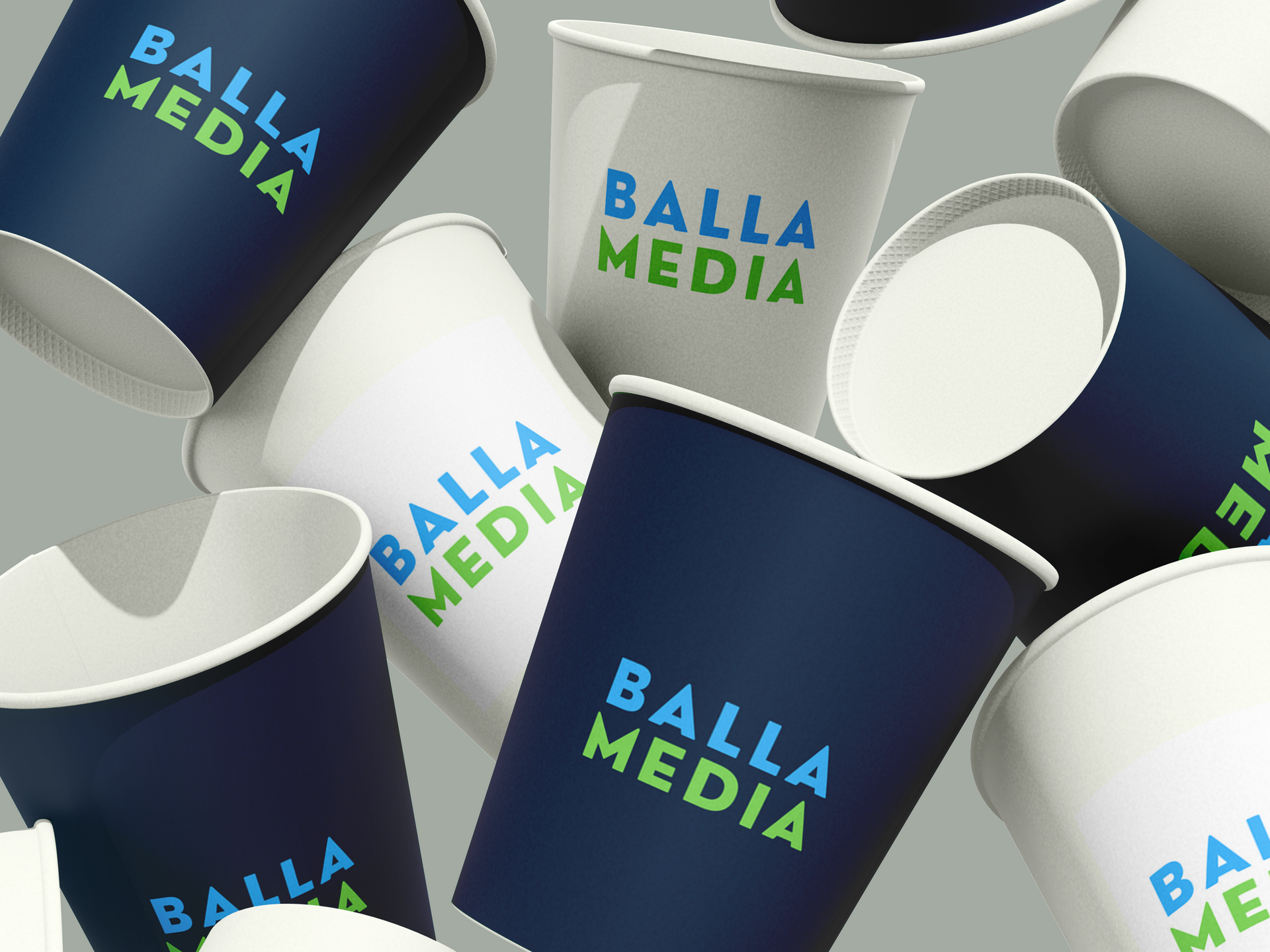 Assorted Balla Media paper cups in navy, white, and light gray with blue-green logos.
