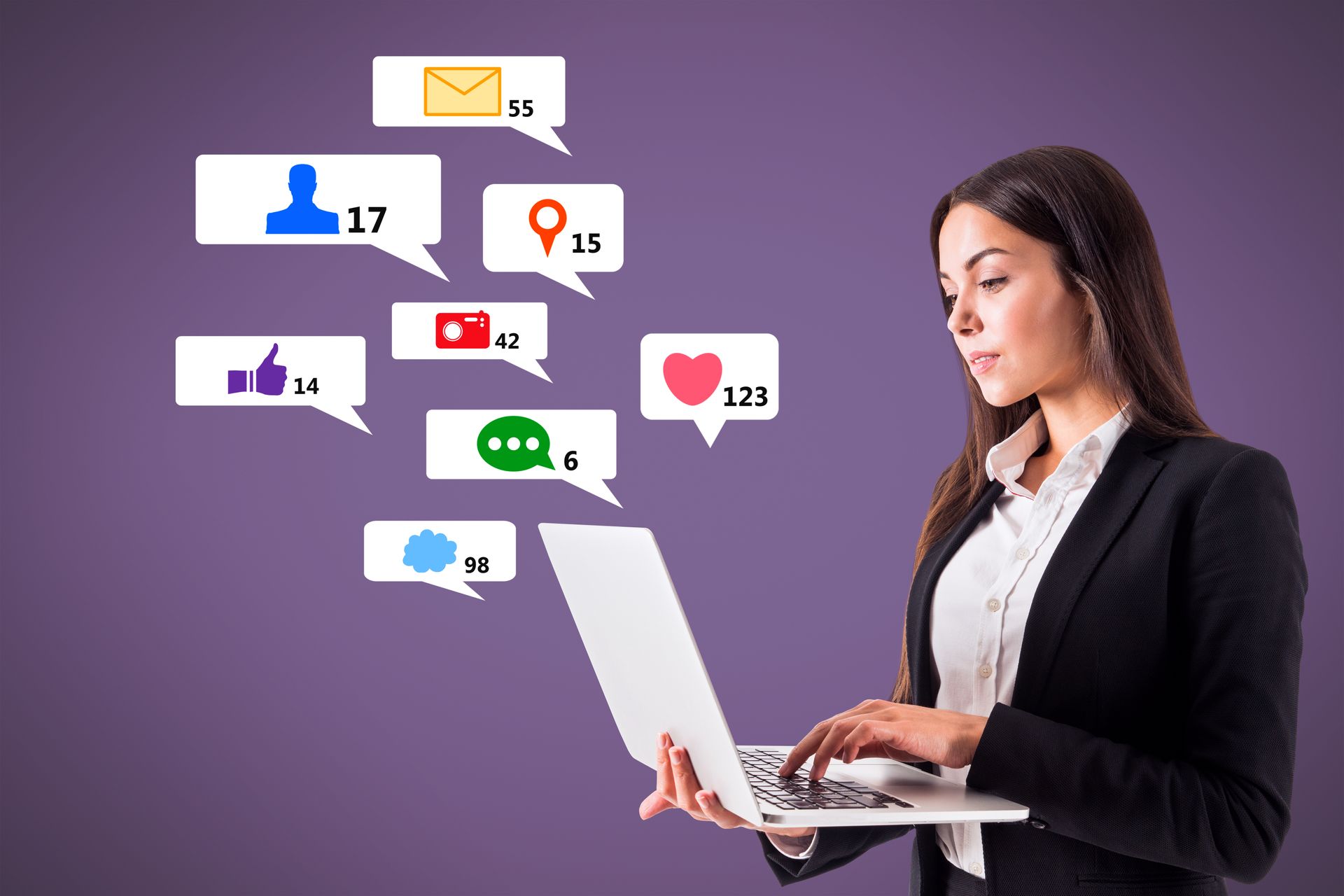 Woman in business suit using laptop, social media icons floating nearby. Purple background.