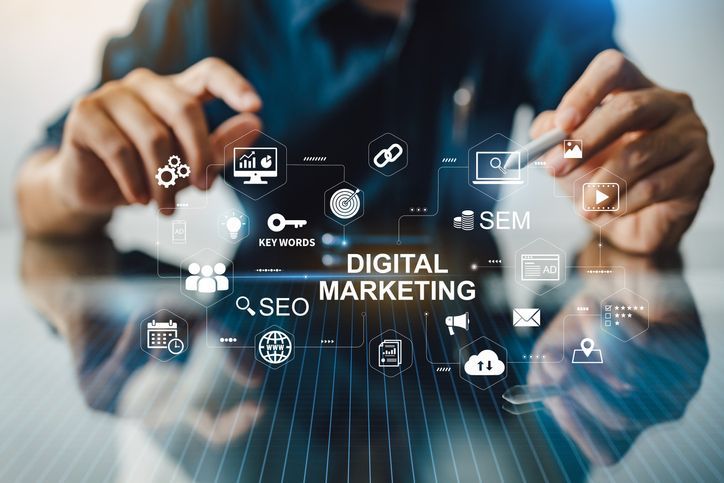 A man is using a tablet with a screen that says digital marketing.