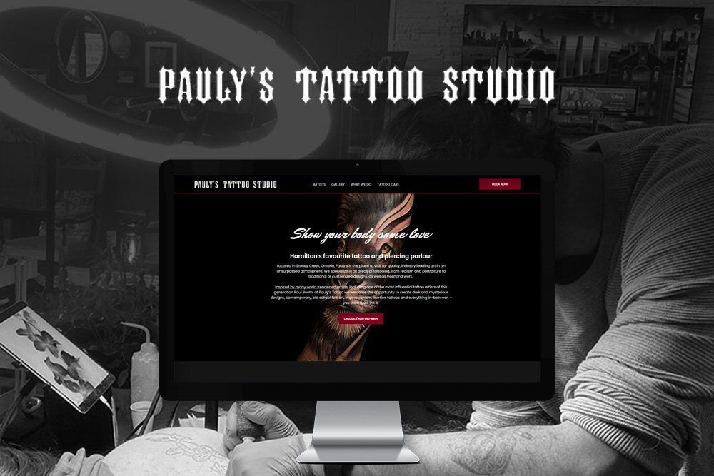 A man is getting a tattoo on his arm at pauly 's tattoo studio