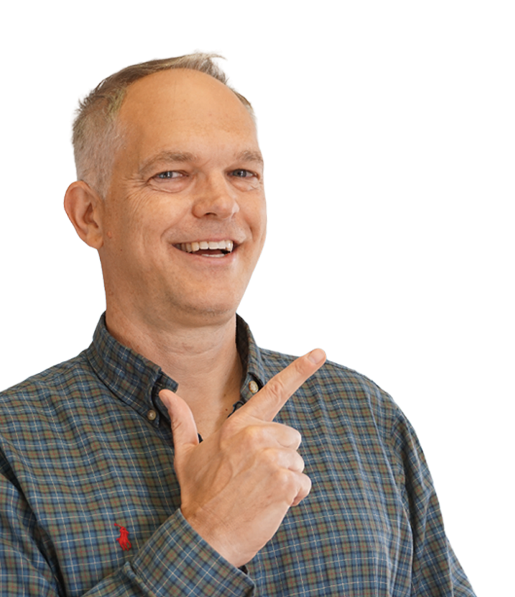 Smiling man in a plaid shirt pointing to the right on a white background