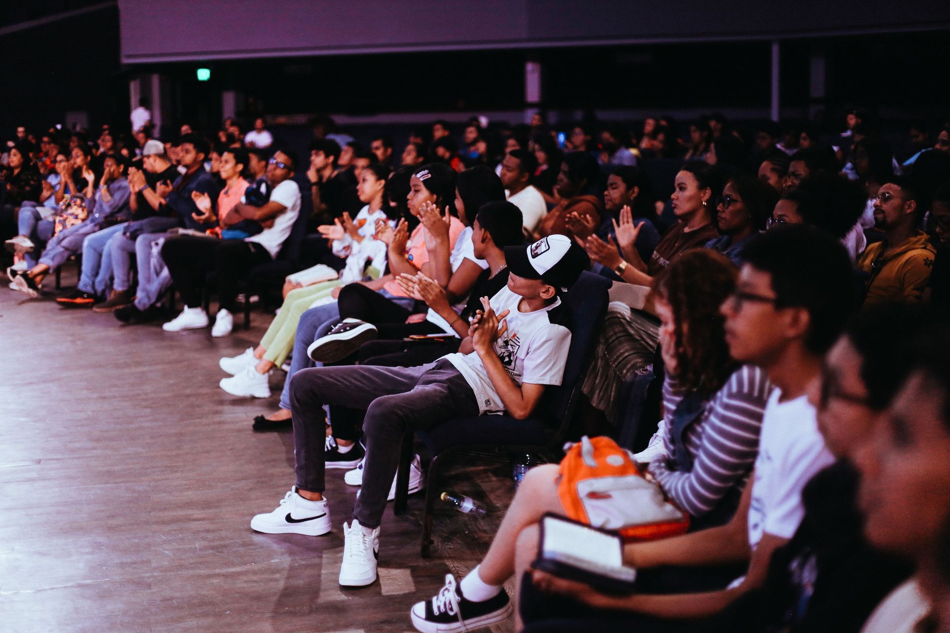 Audience seated in an auditorium, watching a presentation or performance