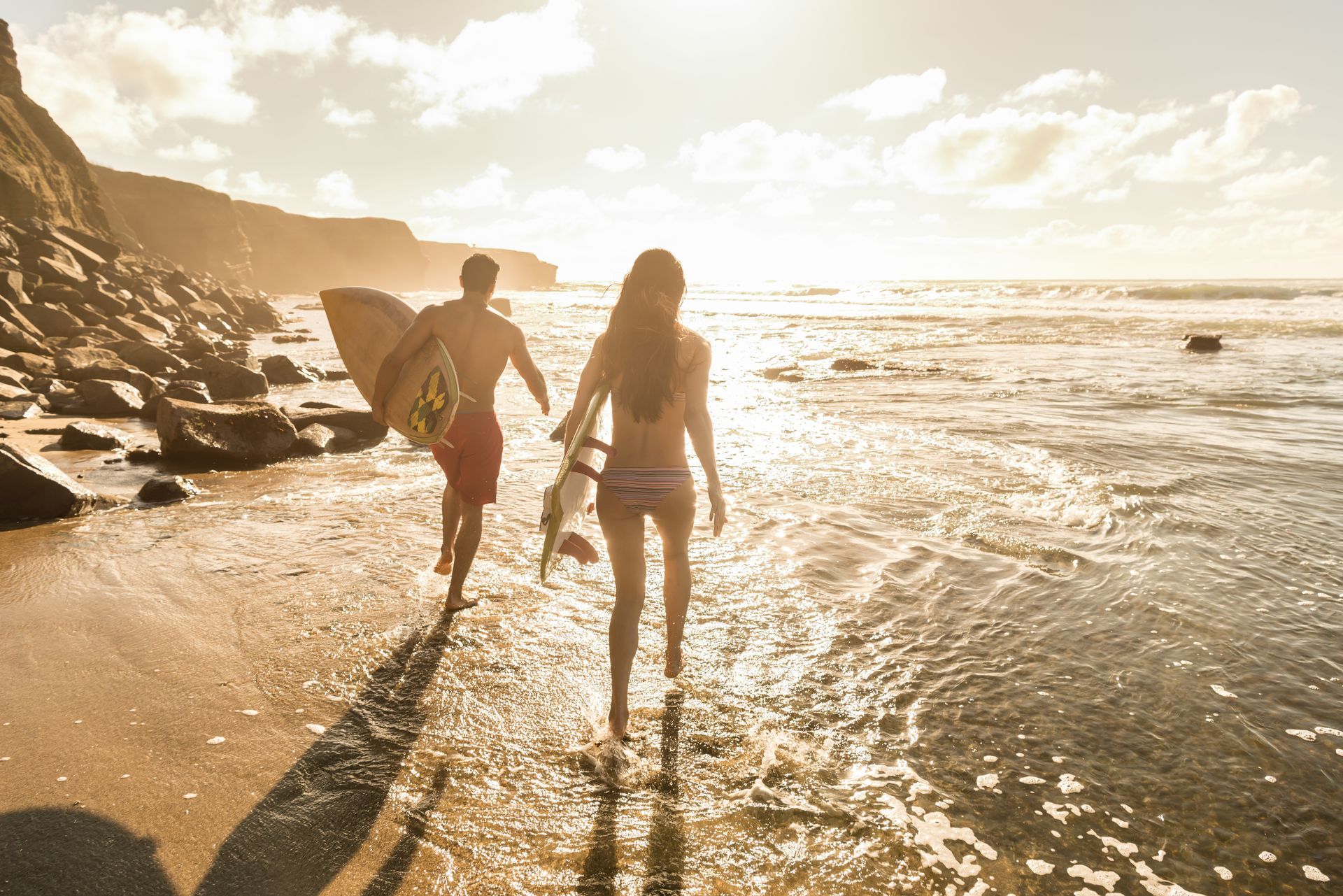 Two surfers walking to the beach