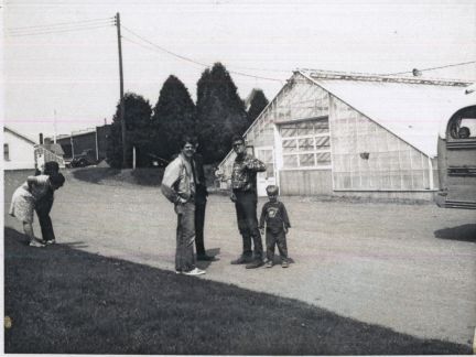 A black and white photo of a group of people standing in front of a building
