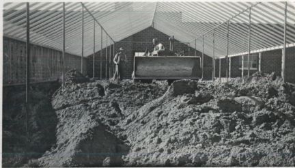 A black and white photo of a large pile of dirt