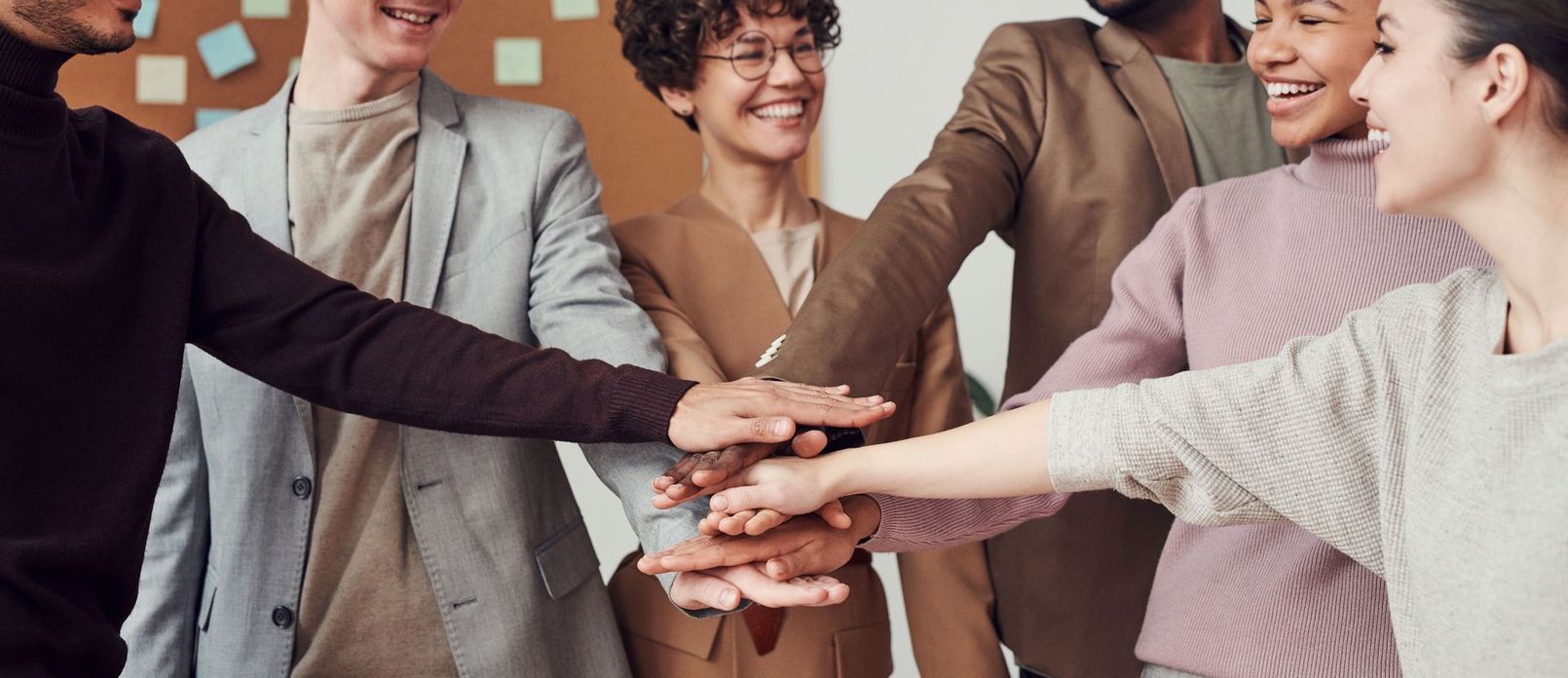 Law firm team stacking hands after a successful trust account cleanup