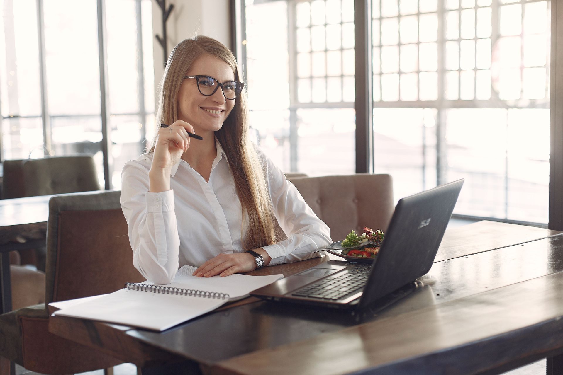 Law firm owner reviewing Texas IOLTA trust account records on a laptop in a bright office
