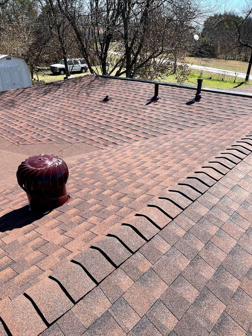 A close up of a roof with a drain on it.