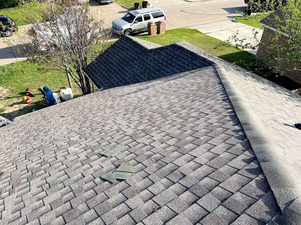An aerial view of a roof with a car parked on the side of it.