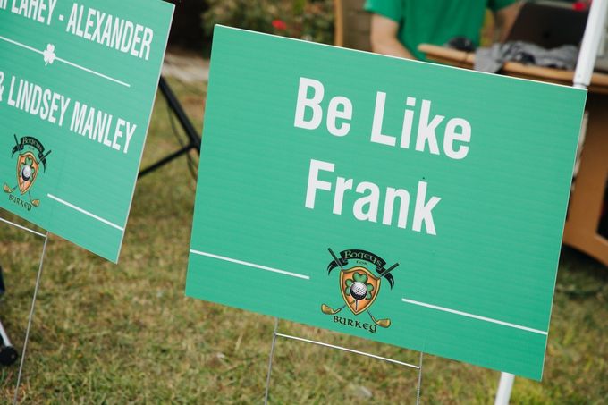 A green sign that says be like frank on it