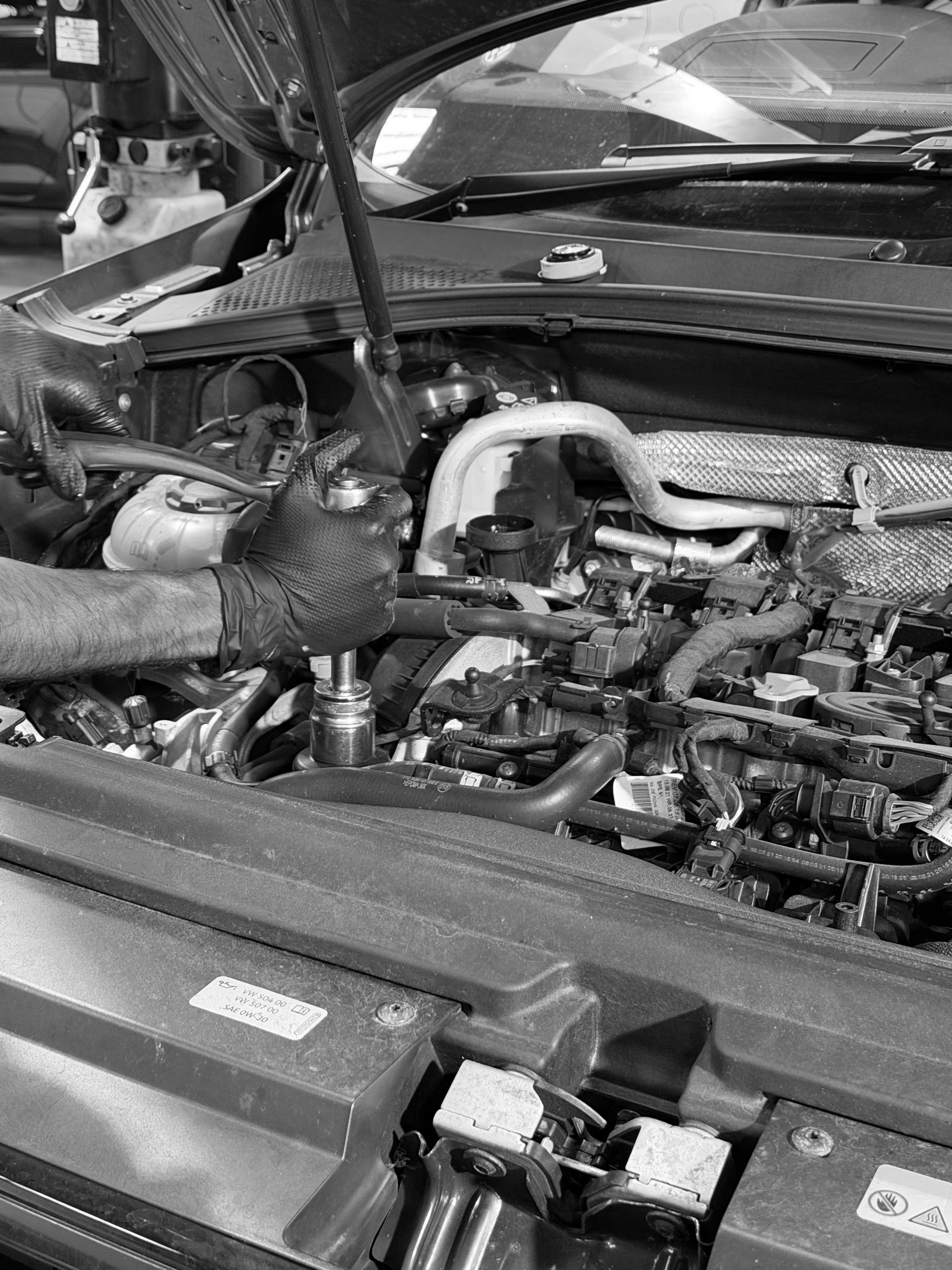 Oil change and filter replacement in auto workshop