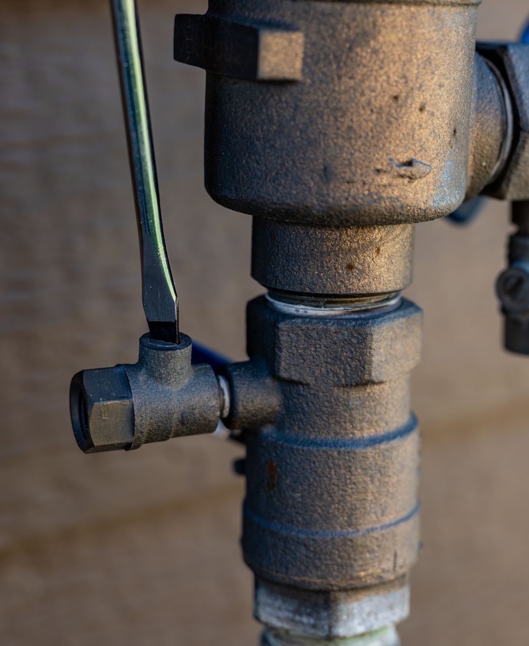 A close up of a valve with a wrench on it