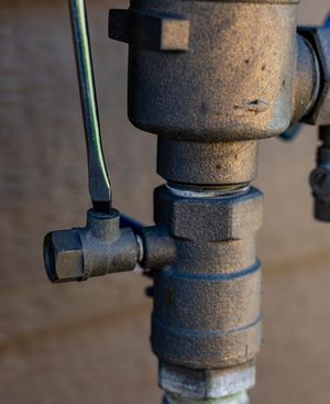 A close up of a valve with a wrench on it