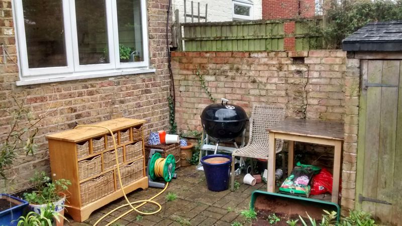The existing patio was covered in empty pots, hose, BBQ and rubbish. Weeds grow were growing in the paving.